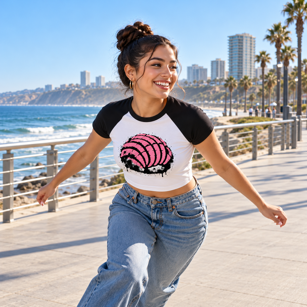 Model roller-skating at the Tijuana waterfront in the white and black Concha Rosa Baby Tee [Color: White with Black]