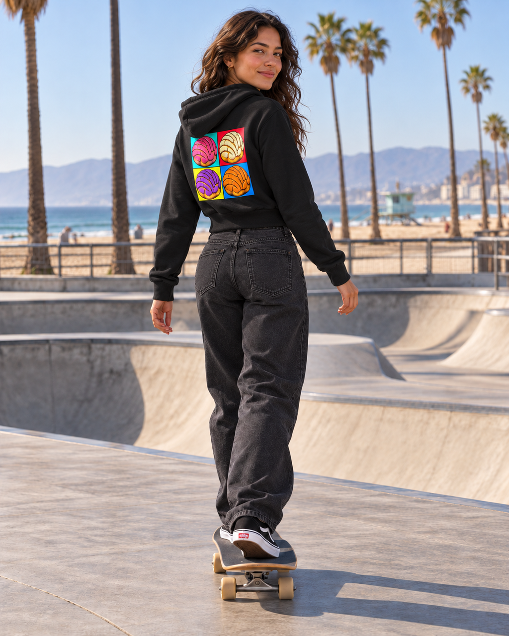 Woman wearing Women's Cropped Full Zip Hoodie in a rear three-quarter view, showing the concha back design [Color: Black] [Model: Women]