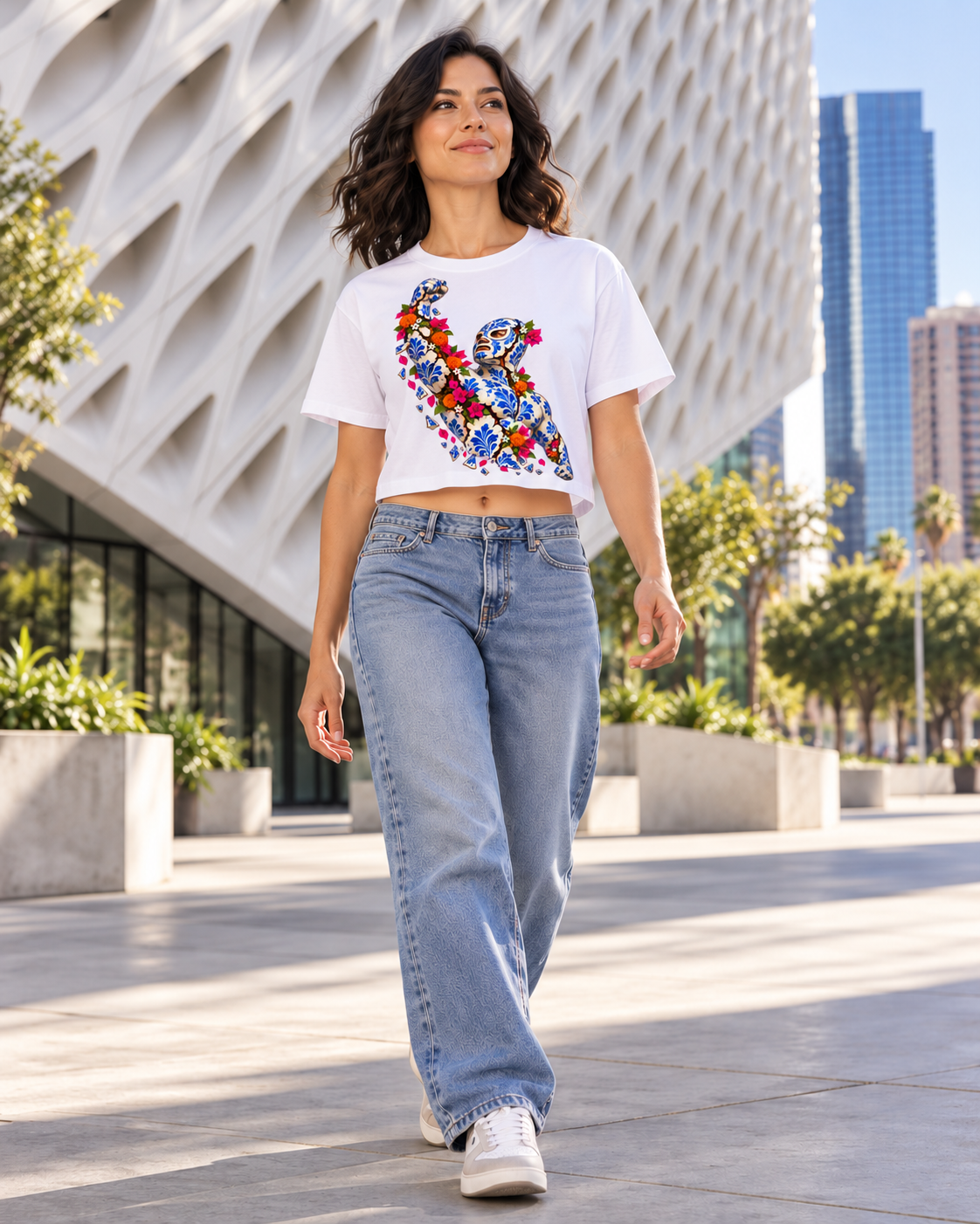 Woman walking in Los Angeles wearing the white cropped Talavera luchador baby tee, matching Tapstitch RU0007 fit [Color: White] [Model: Women]